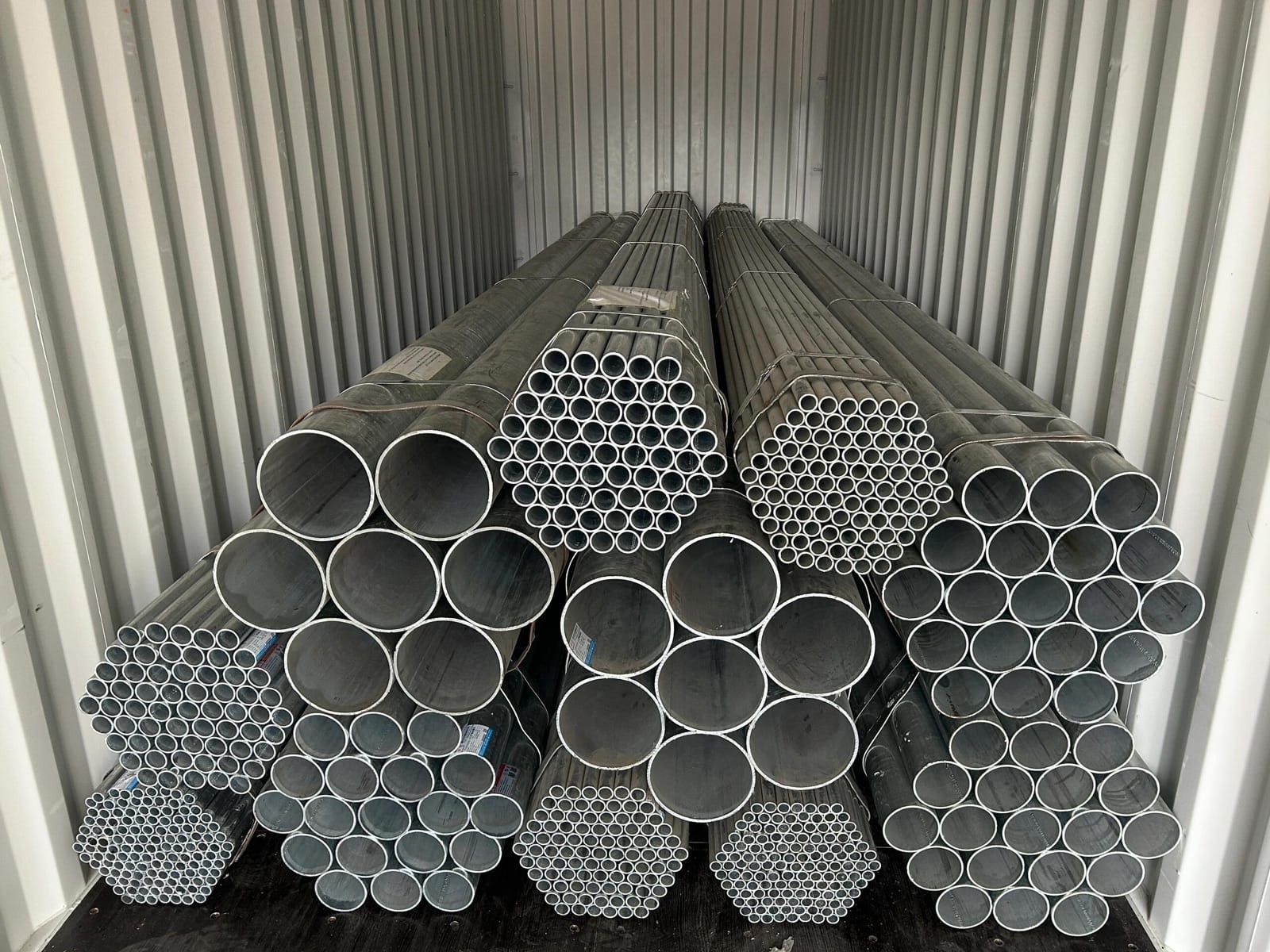 Galvanized steel pipe bundles loaded inside a shipping container in China before export